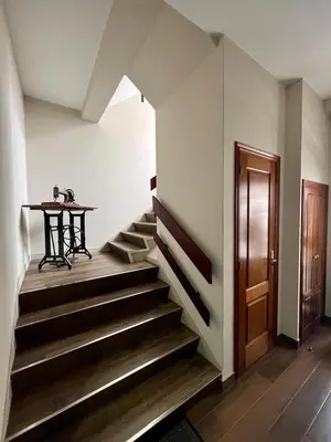 a hallway with stairs and a table and a table at Piso en pleno centro de Miño izquierda in Miño