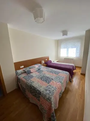 a bedroom with two beds and a window at dpCristal Calvo Sotelo 164, 4D in Sarria