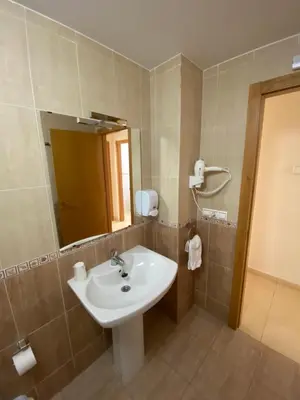 a bathroom with a white sink and a mirror at dpCristal Calvo Sotelo 164, 4D in Sarria