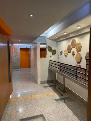 a hallway in a building with fossils on the wall at dpCristal Calvo Sotelo 164, 4D in Sarria