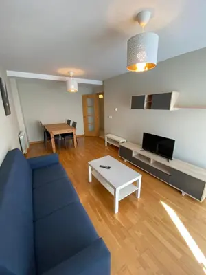 a living room with a blue couch and a table at dpCristal Calvo Sotelo 164, 4D in Sarria