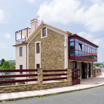 a building on the side of the street at Apartamento con jardín en San Sadurniño in Santa María La Mayor del Rosario