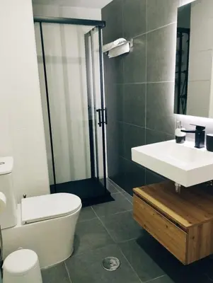 a bathroom with a white sink and a toilet at Viveiro MSuites in Viveiro