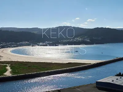 a beach with a fountain in the water at Casa Lolita 2 in Viveiro