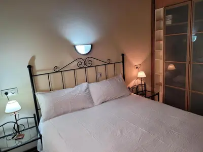 a bedroom with a white bed and two lamps at La Casa de Trefacio in Trefacio