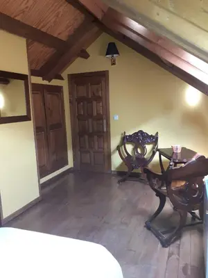 a living room with a table and a chair at OSO4 in Pola de Somiedo