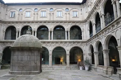 a large building with many arches and a pillar at Delta in Monforte de Lemos