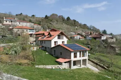 a group of houses with solar panels on a hill at Casa da Cocha in Chantada