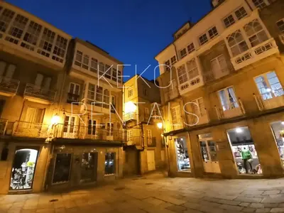 a group of buildings at night with lights at Arq Plaza Mayor in Viveiro