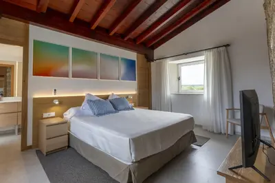 a living room with a couch and a table and chairs at Reverence Villas Caldelas in Antas de Ulla