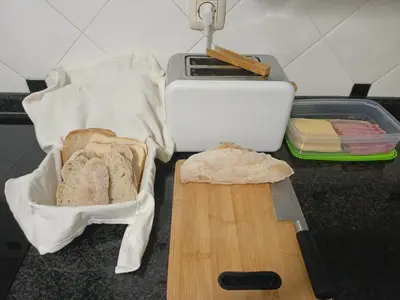 a cutting board with bread and a knife on a counter at Cesuresrooms2 in Puentecesures