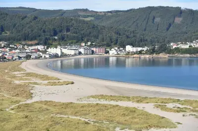 an aerial view of a beach with a town in the background at Mariña in Viveiro