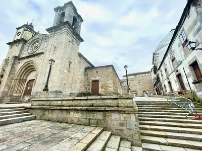 an old stone church with a clock tower and stairs at The Cliffs - MarCastelos in Viveiro