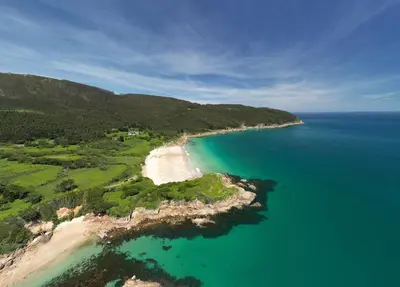 an aerial view of a beach and the ocean at The Cliffs - MarCastelos in Viveiro