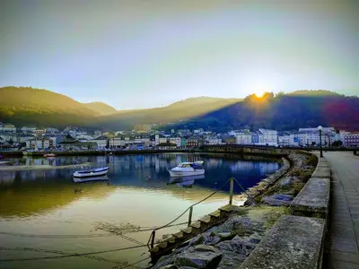 a city with boats in a body of water at The Cliffs - Casa Catuxa in Viveiro