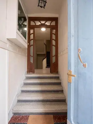 a hallway with stairs with a blue door at La Fantástica Pontedeume 4 in Puentedeume