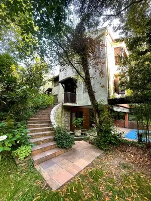 a house with a staircase leading to a house at As Erdades in Ourense