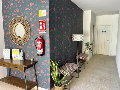 a room with a mirror and two chairs and a table at The Cliffs A Ribeira - Pampillosa in Foz