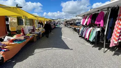 a market with a bunch of tables filled with clothes at The Cliffs A Ribeira - Peizas in Foz