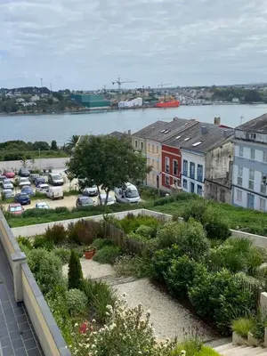 a view from a balcony of a city with a parking lot at Apartamentos Buenos Aires,en el centro de Ribadeo con vistas a la ría in Ribadeo