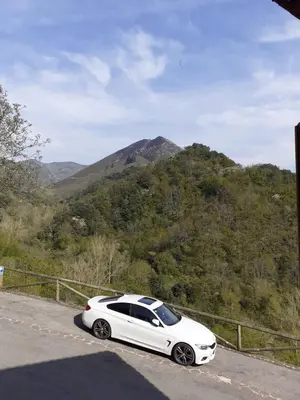 a white car parked on the side of a road at Casa del OSO2 in Pola de Somiedo