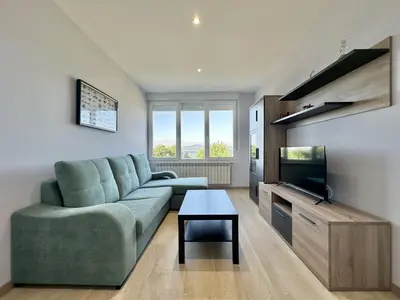 a living room with a couch and a flat screen tv at Front Beach I in Sada