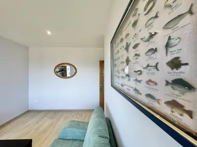 a living room with a wall mural of fish at Sea Horizon I in Sada