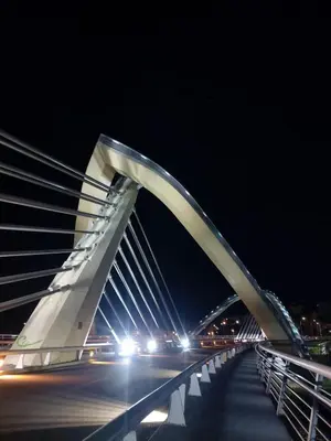 a large white bridge at night with cars at YourHouse Fontevella II in Ourense