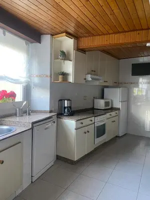 a kitchen with white appliances and a wooden ceiling at VUT Boente 2 in Boente