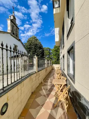 a row of benches sitting on the side of a building at The Cliffs - AT Seiramar in Viveiro
