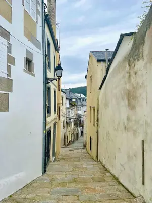 an alley in an old town with buildings at The Cliffs - AT Seiramar Area in Viveiro