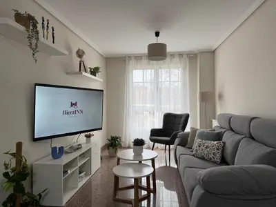 a living room with a couch and a tv at BierzINN Alojamientos - Martina II in Ponferrada