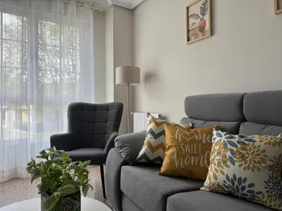 a living room with a couch and a chair at BierzINN Alojamientos - Martina II in Ponferrada