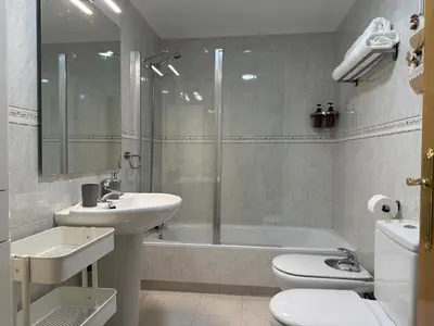 a bathroom with a sink and a toilet and a shower at BierzINN Alojamientos - Martina II in Ponferrada