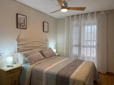 a bedroom with a bed and a ceiling fan at BierzINN Alojamientos - Martina in Ponferrada
