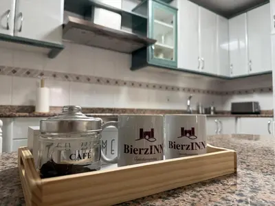 two mugs on a wooden tray on a kitchen counter at BierzINN Alojamientos - Martina in Ponferrada