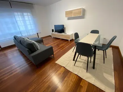 a living room with a couch and a table and chairs at A un Paso in Caldas de Reis