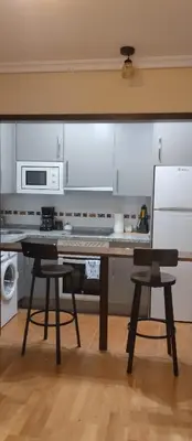 a kitchen with a table and two chairs at La Vega De Somiedo in Pola de Somiedo
