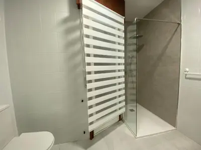 a bathroom with a toilet and a shower at A tres Pasos in Caldas de Reis