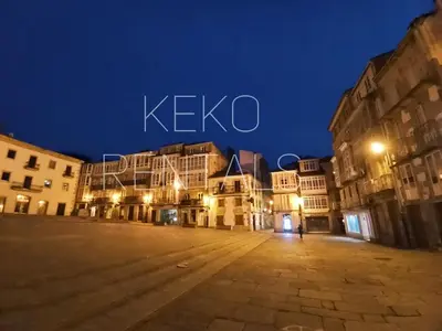 an empty street at night in a city at El Atico de Arriba in Viveiro