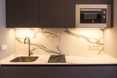 a kitchen counter with a sink and a microwave at Treixadura in Pincelo