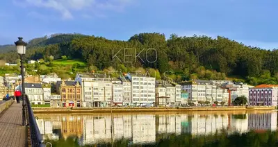 a group of buildings next to a body of water at Casa das Mariñas in Viveiro