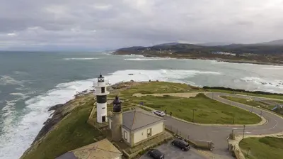 an aerial view of a lighthouse on the ocean at EnSAN CIPRIAN Atico en Urb Río Cobo in San Ciprián