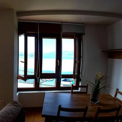 a dining room with a table and a large window at Figueras 6 in figueras