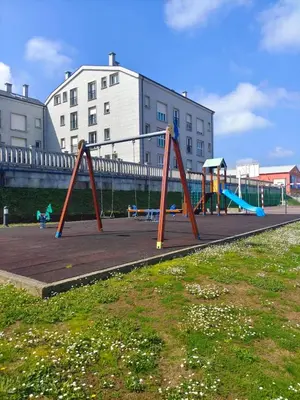 a playground with a swing set in a park at Nuestro sueño jurásico in Barreiros