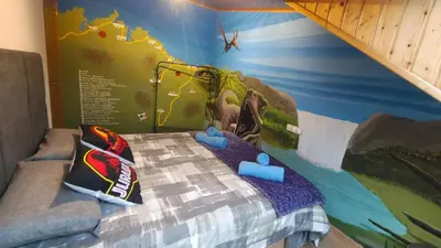 a childs bedroom with a bed with a mural at Nuestro sueño jurásico in Barreiros