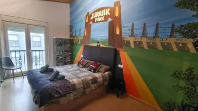 a bedroom with a sign for a walt disney park at Nuestro sueño jurásico in Barreiros