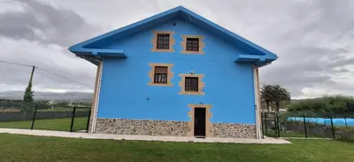 a blue house with a blue roof at Casa Julia in Barreiros