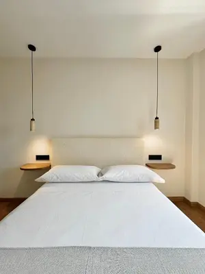 a bedroom with a white bed with two pillows at Lemos Agra in Monforte de Lemos