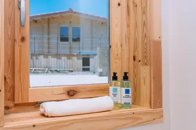 a window with a towel and two bottles on a shelf at Cabañas de Allariz - Cabaña 5 in Allariz